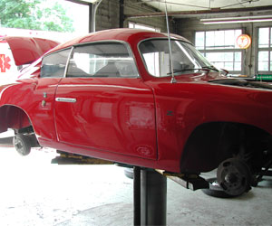 Red 59 Fiat Abarth on the hoist at Van's Garage